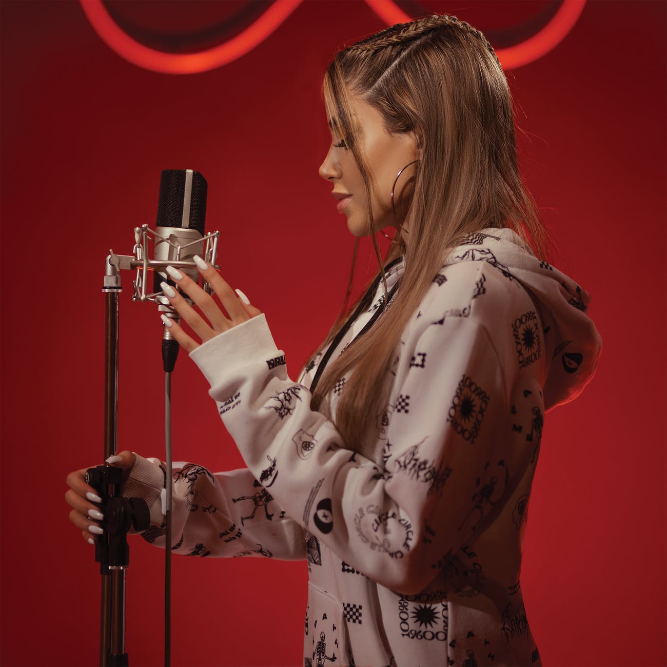 young woman with microphone against red background